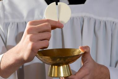 web3-priest-eucharist-host-shutterstock_241121287.jpg